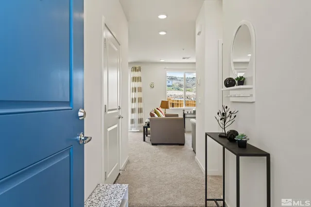 a view of living room with furniture and a potted plant