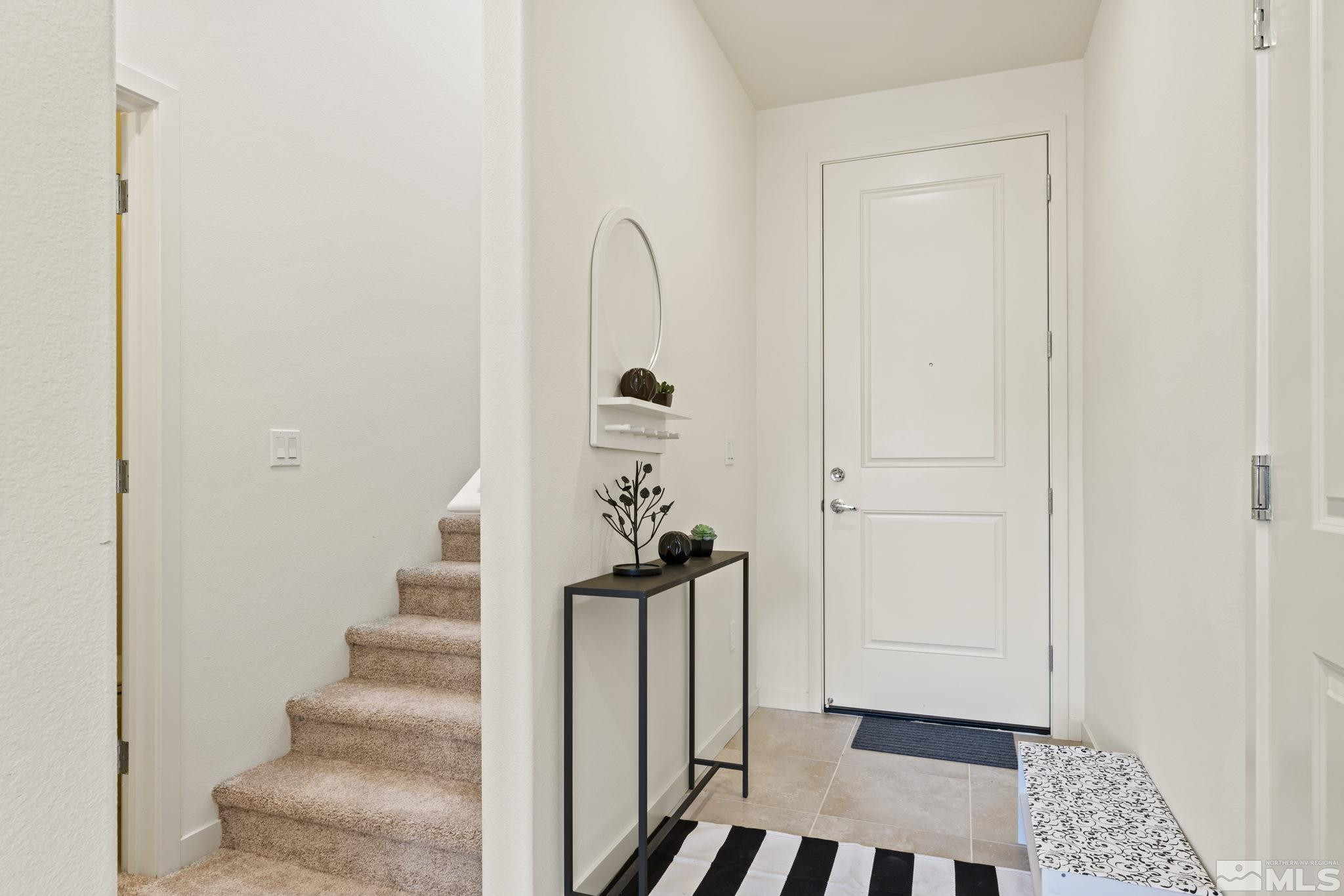 4920 Little Rock Way Sun Valley, NV 89433 - Photo 4 of 37 a view of a hallway with wooden floor and staircase