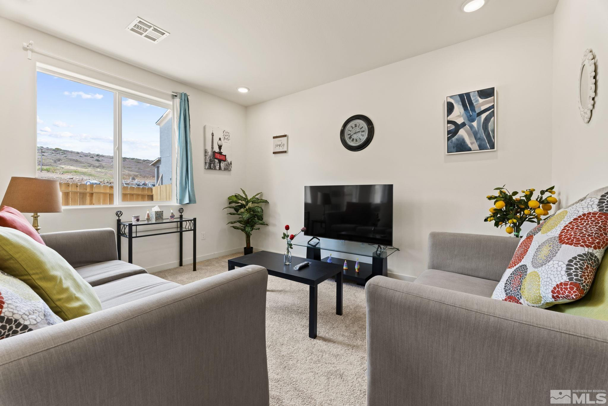 4920 Little Rock Way Sun Valley, NV 89433 - Photo 6 of 37 a living room with furniture and a flat screen tv