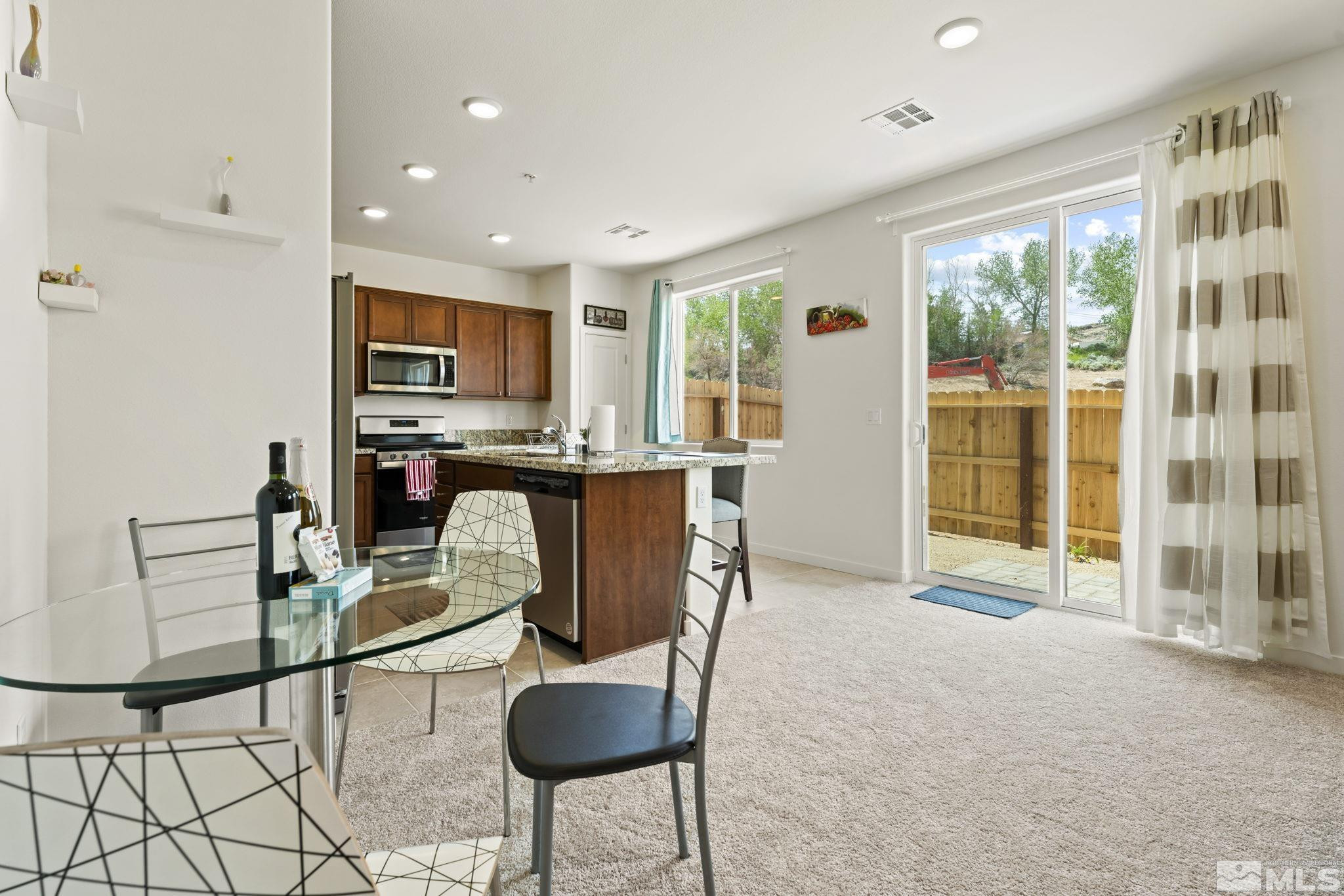 4920 Little Rock Way Sun Valley, NV 89433 - Photo 9 of 37 a living room with furniture a flat screen tv and a refrigerator