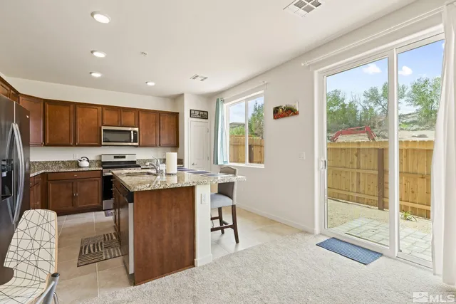 a kitchen with a sink a counter top space a refrigerator and cabinets