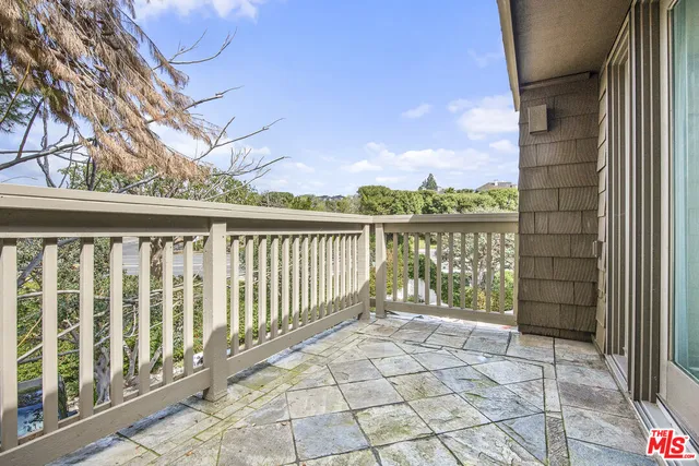 a view of a porch with wooden floor and fence