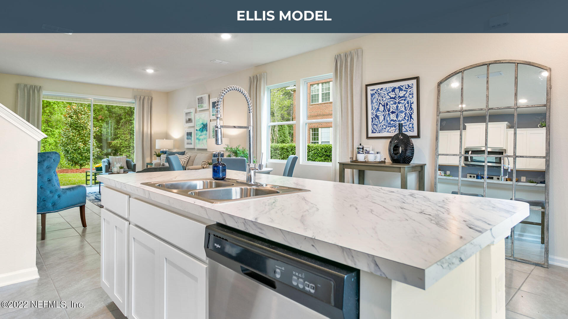 a kitchen with a sink a counter top space and living room view