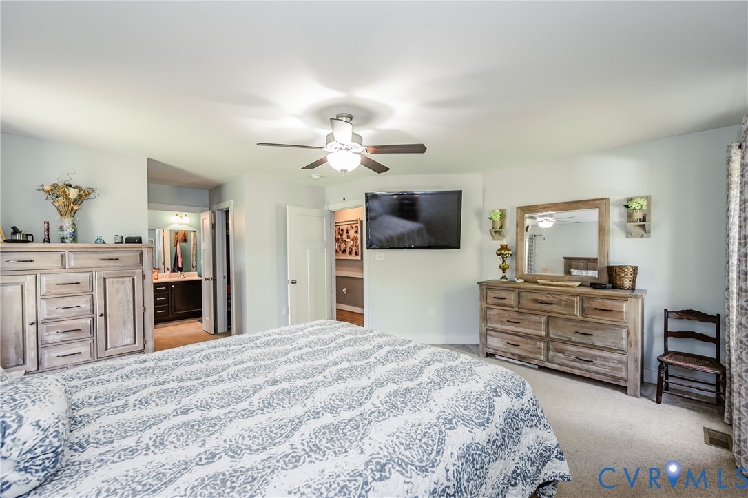 915 Manchester Road Bumpass, VA 23024 - Photo 22 of 49 a bedroom with a bed and a flat screen tv