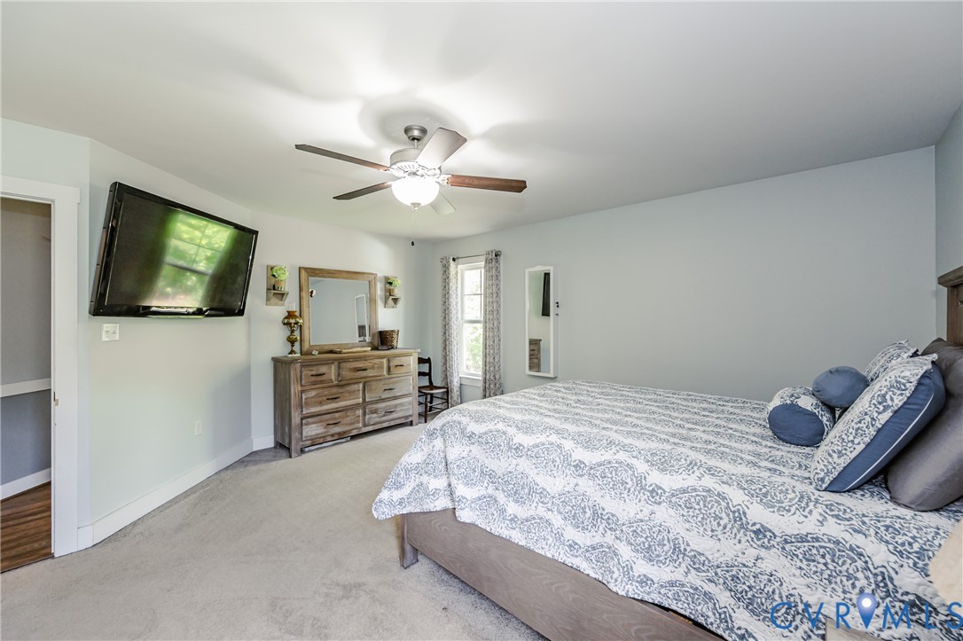 915 Manchester Road Bumpass, VA 23024 - Photo 23 of 49 a bedroom with a bed and a flat screen tv