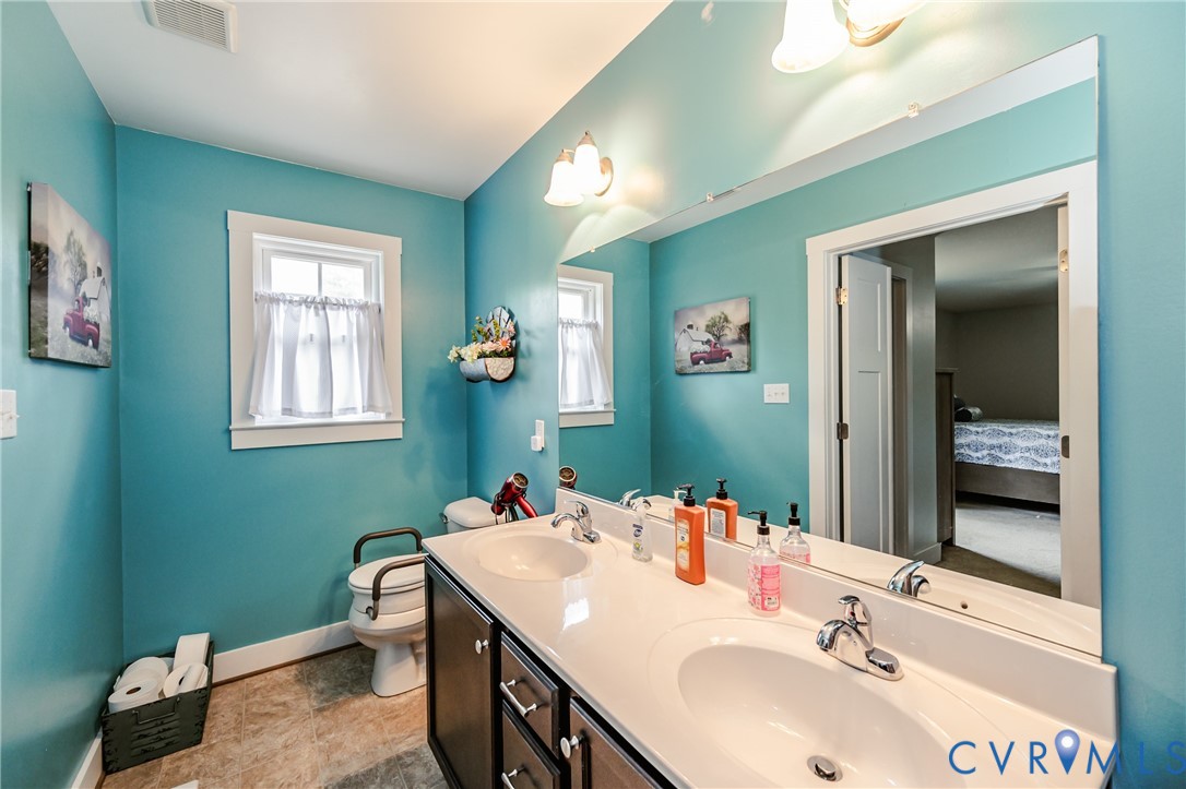 915 Manchester Road Bumpass, VA 23024 - Photo 24 of 49 a bathroom with a sink and a mirror