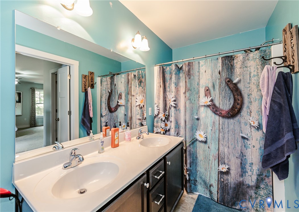 915 Manchester Road Bumpass, VA 23024 - Photo 25 of 49 a bathroom with a sink vanity mirror and tub