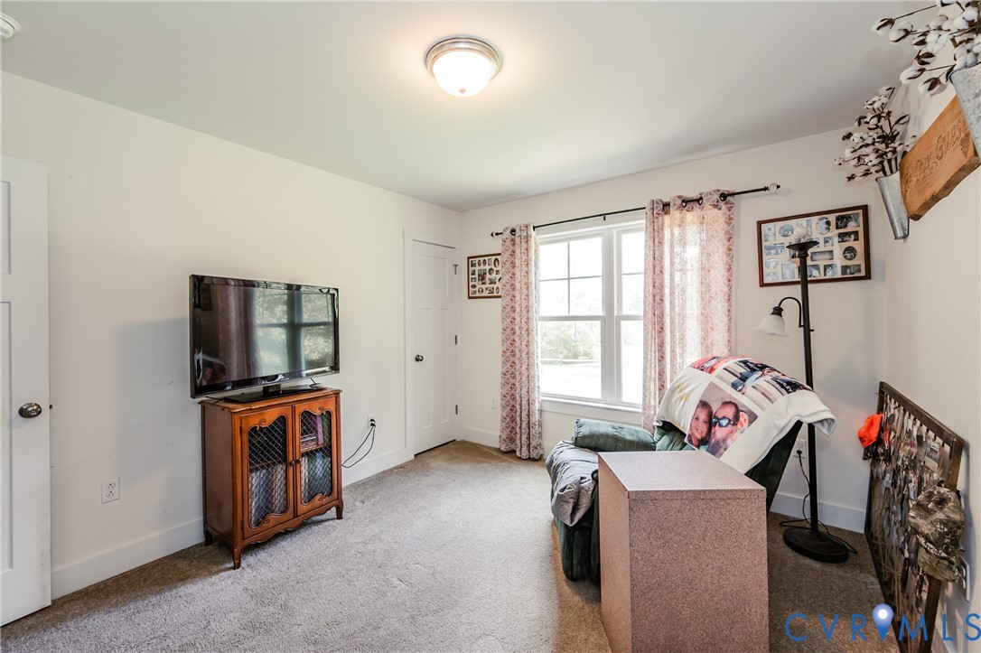 915 Manchester Road Bumpass, VA 23024 - Photo 28 of 49 a living room with furniture and a flat screen tv