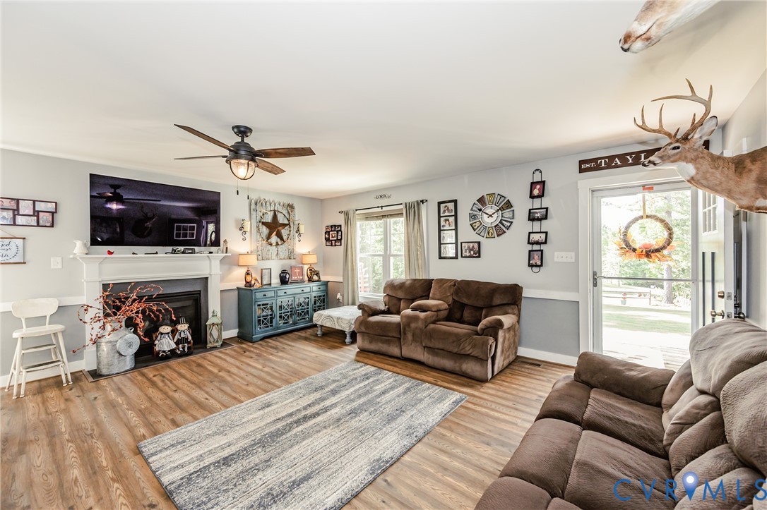 915 Manchester Road Bumpass, VA 23024 - Photo 6 of 49 a living room with furniture a fireplace and a flat screen tv