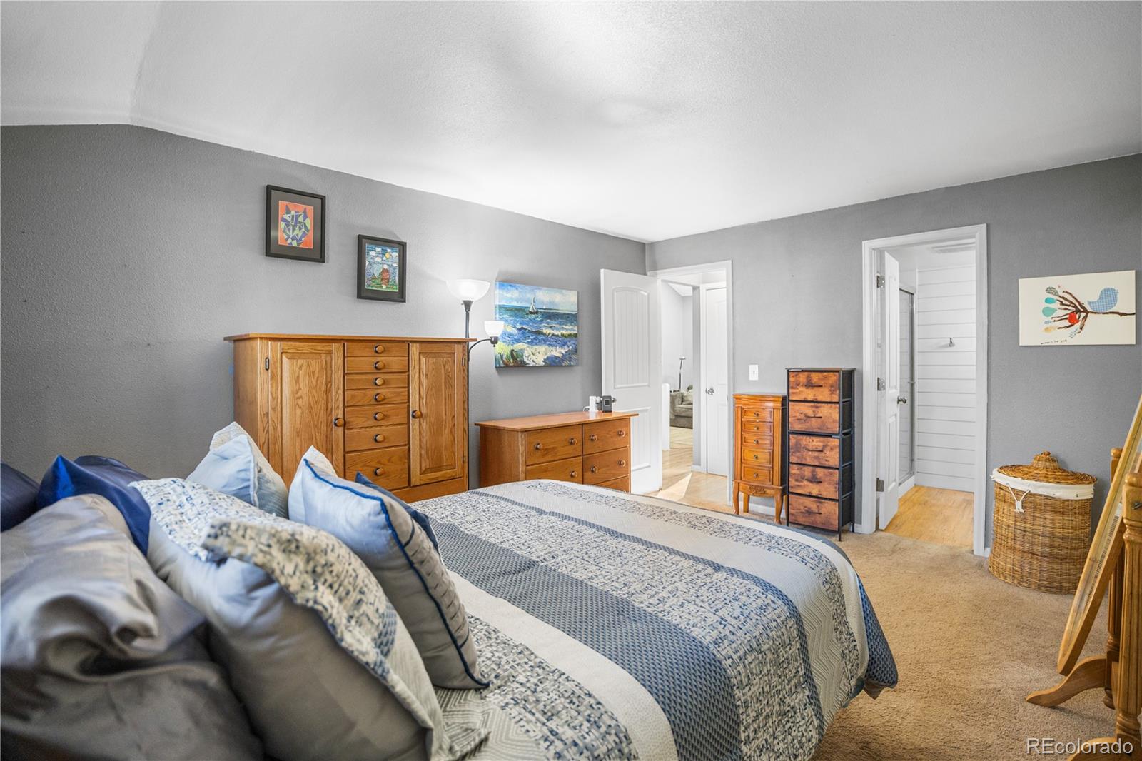 8567 Rabbitbrush Way Parker, CO 80134 - Photo 11 of 46 a bedroom with a bed and dresser