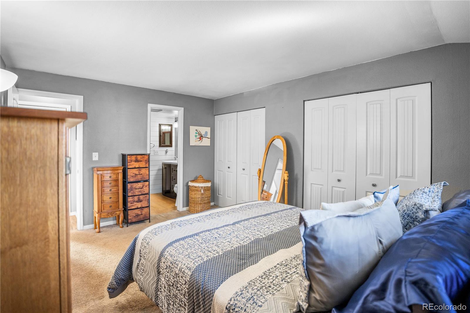 8567 Rabbitbrush Way Parker, CO 80134 - Photo 12 of 46 a bedroom with bed and wooden floor