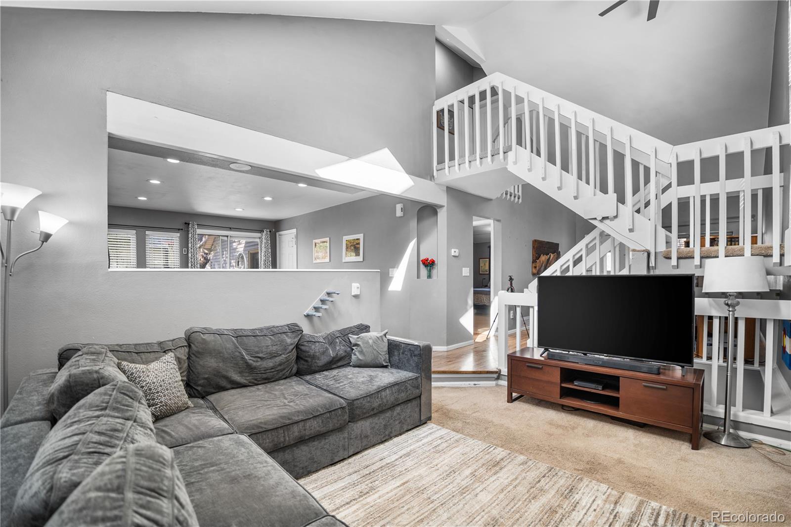 8567 Rabbitbrush Way Parker, CO 80134 - Photo 14 of 46 a living room with furniture and a flat screen tv