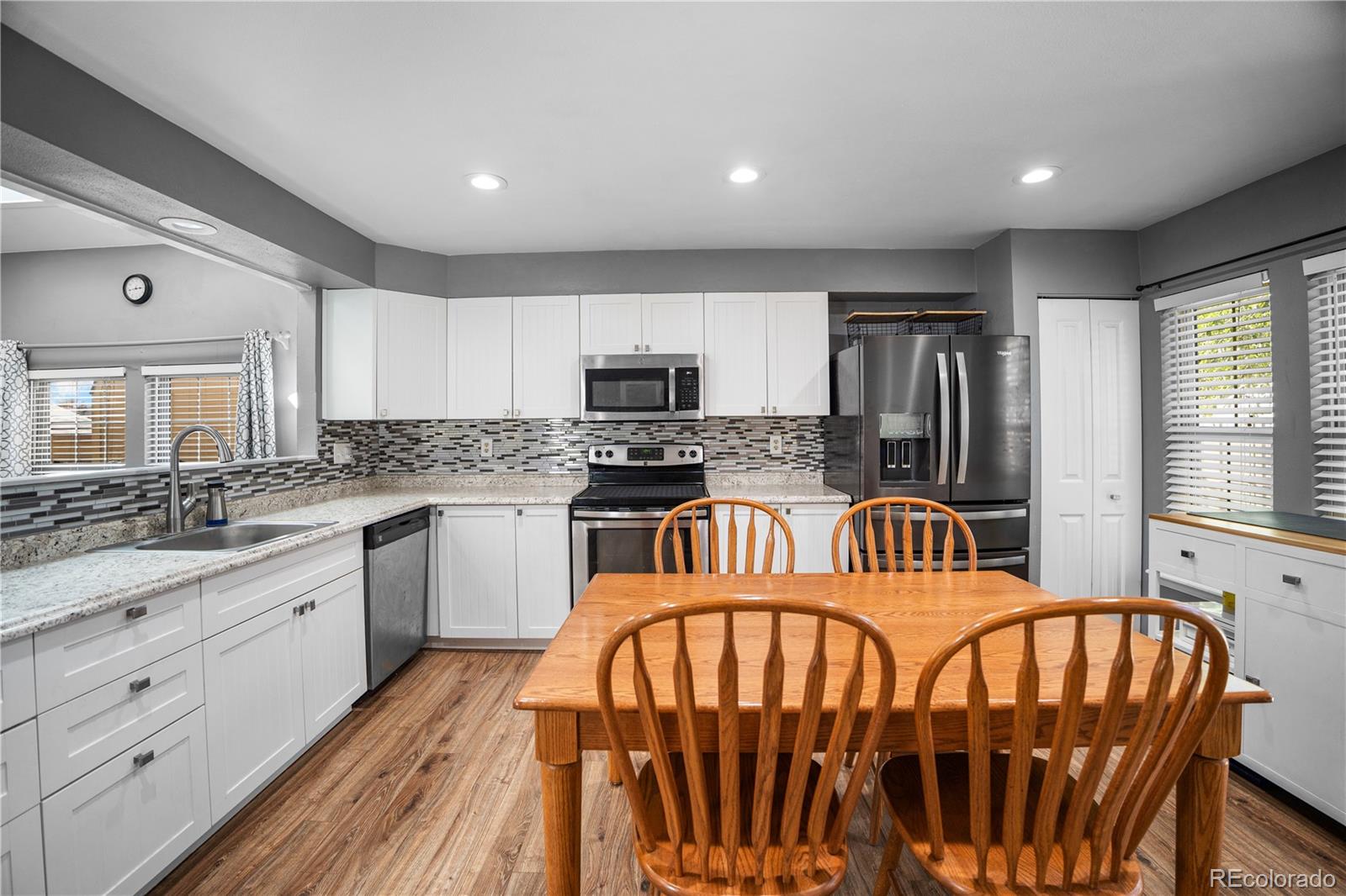 8567 Rabbitbrush Way Parker, CO 80134 - Photo 19 of 46 a kitchen with sink a microwave and refrigerator