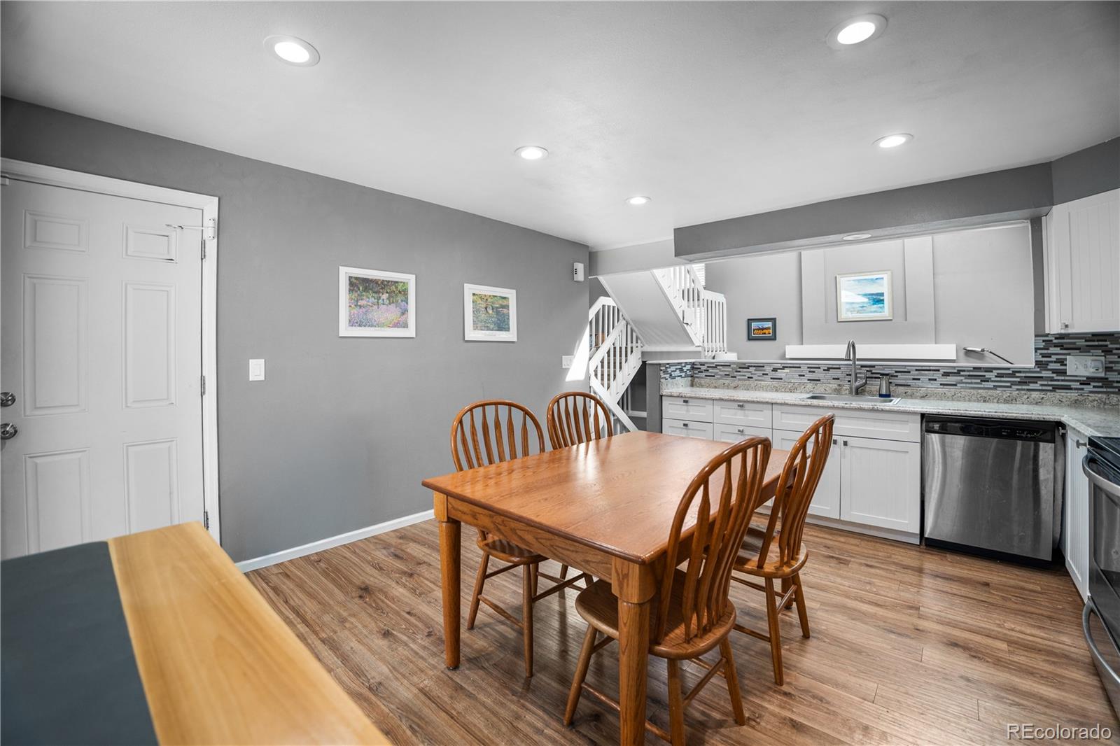 8567 Rabbitbrush Way Parker, CO 80134 - Photo 22 of 46 a view of a dining room with furniture and wooden floor