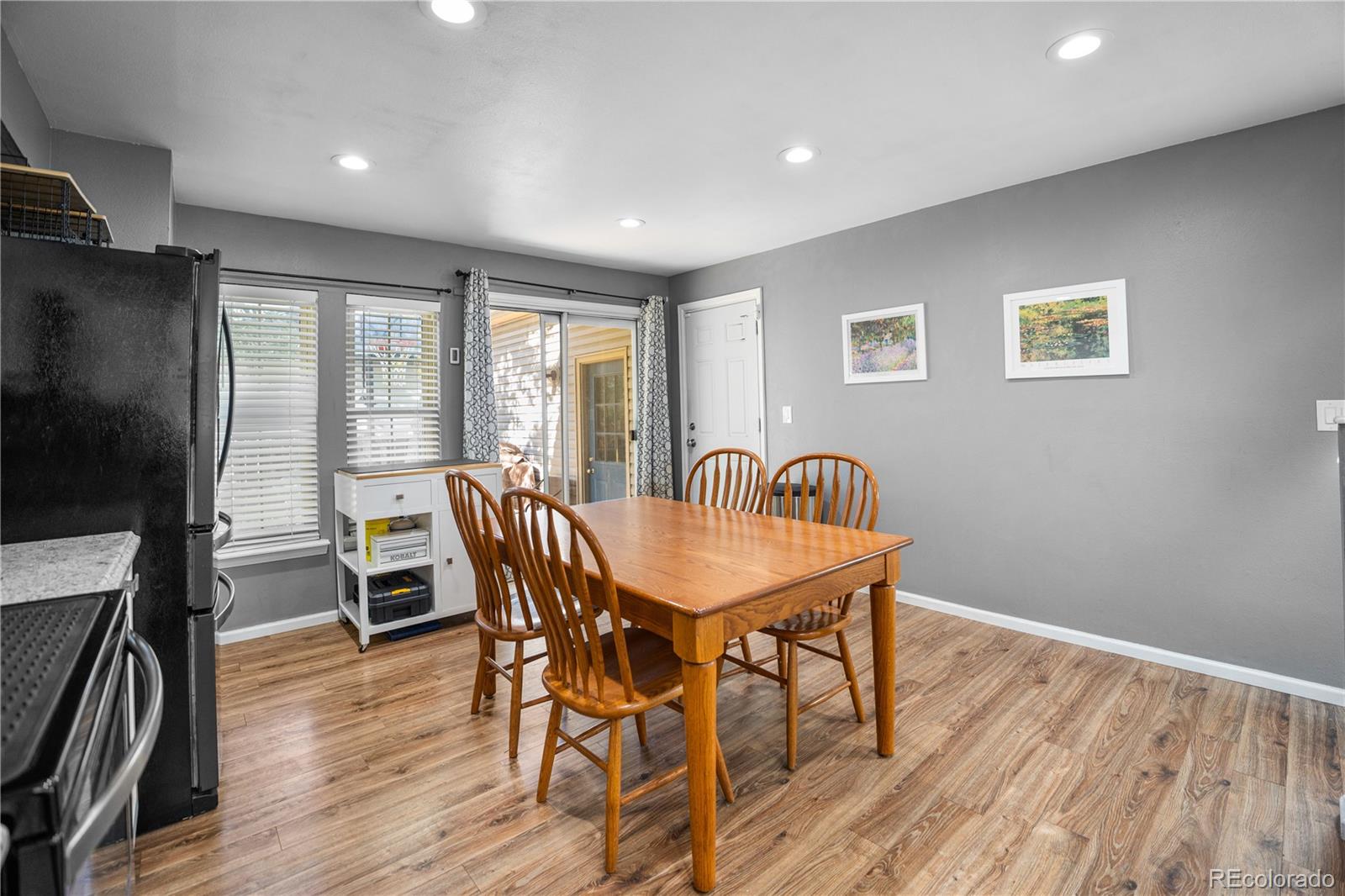 8567 Rabbitbrush Way Parker, CO 80134 - Photo 23 of 46 a view of a dining room with furniture window and wooden floor