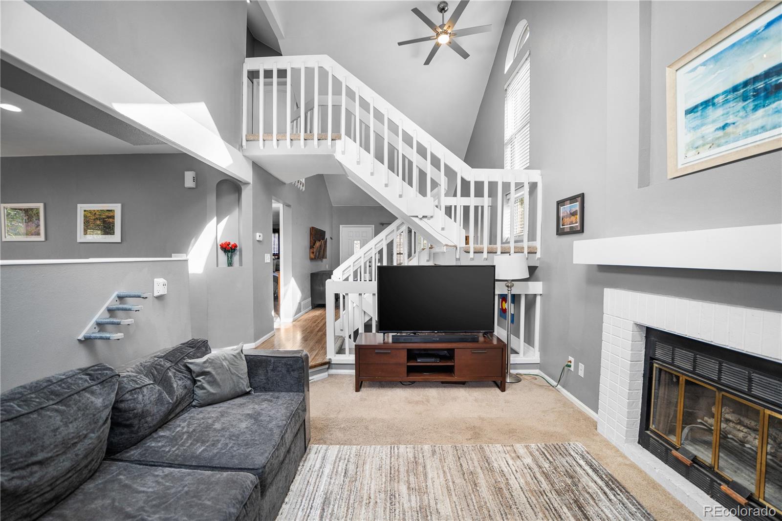 8567 Rabbitbrush Way Parker, CO 80134 - Photo 24 of 46 a living room with furniture and a flat screen tv