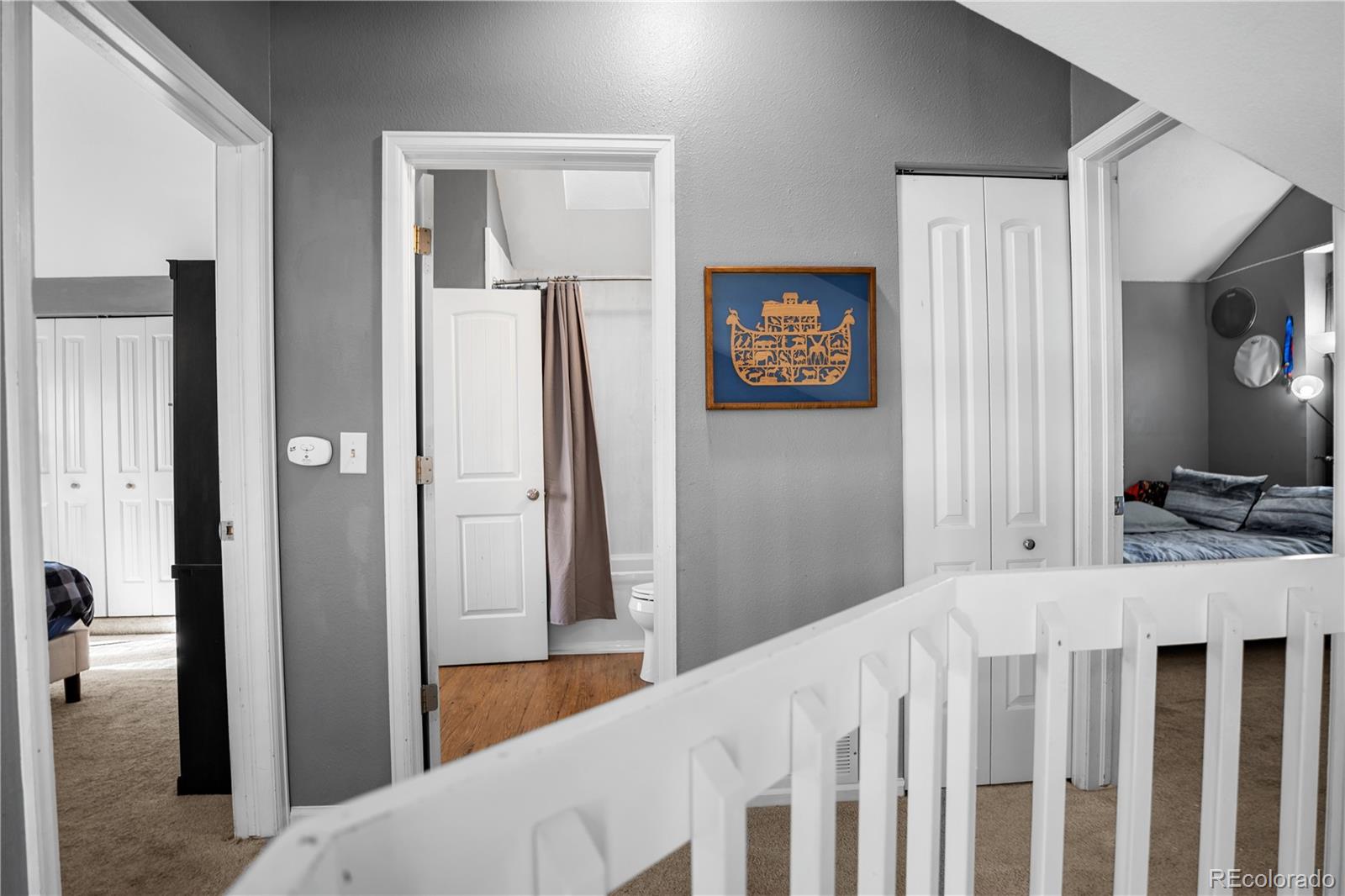 8567 Rabbitbrush Way Parker, CO 80134 - Photo 26 of 46 a bedroom with a bed and a view of bathroom