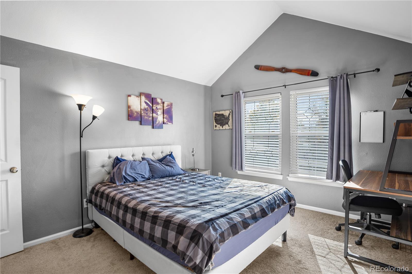 8567 Rabbitbrush Way Parker, CO 80134 - Photo 28 of 46 a bedroom with a bed and a flat screen tv