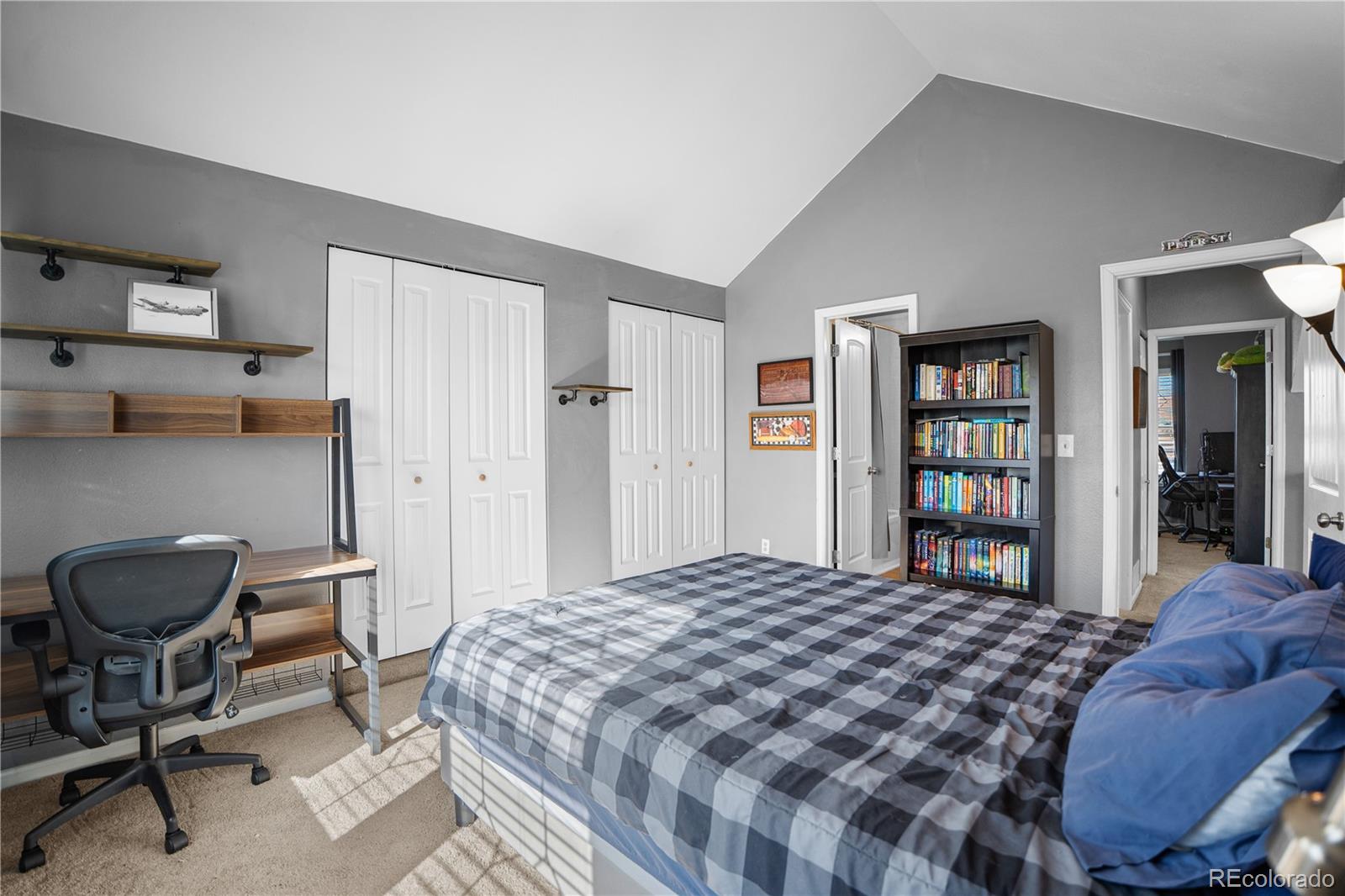 8567 Rabbitbrush Way Parker, CO 80134 - Photo 29 of 46 a bedroom with a large bed and a chair