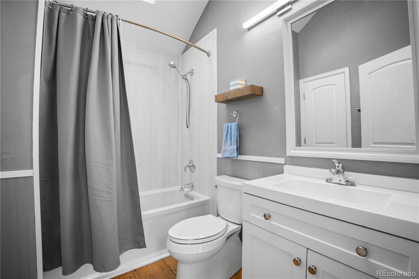 8567 Rabbitbrush Way Parker, CO 80134 - Photo 30 of 46 a bathroom with a sink a toilet a mirror and shower