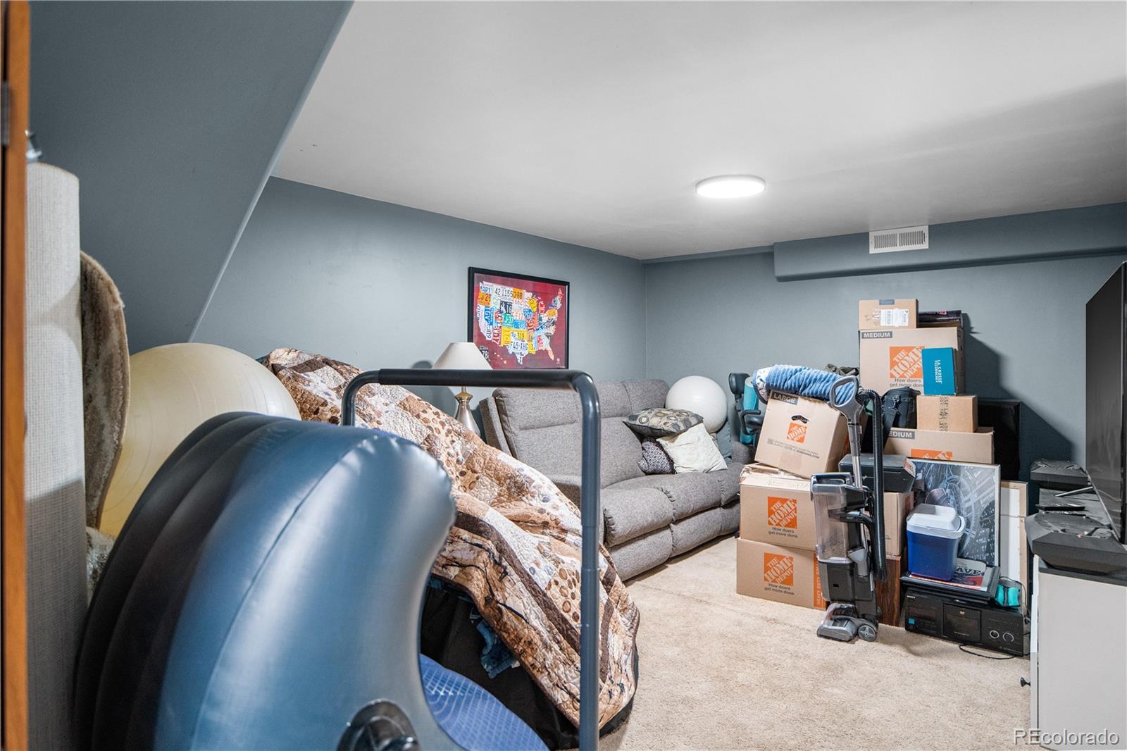 8567 Rabbitbrush Way Parker, CO 80134 - Photo 32 of 46 a living room with furniture and a flat screen tv