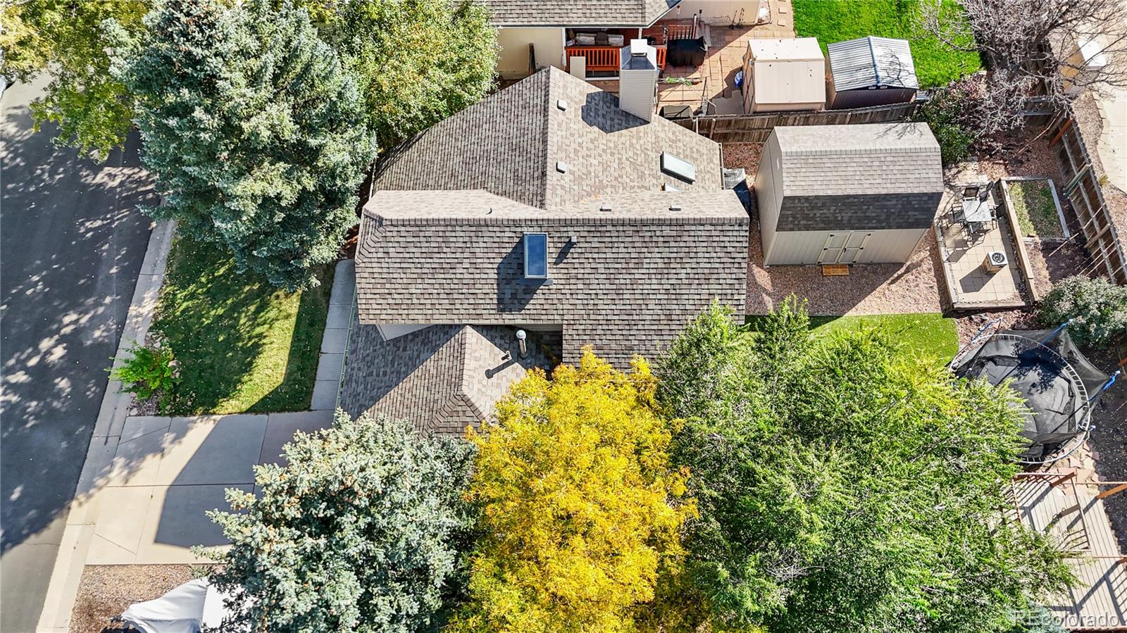 8567 Rabbitbrush Way Parker, CO 80134 - Photo 45 of 46 an aerial view of a house with a yard and large trees