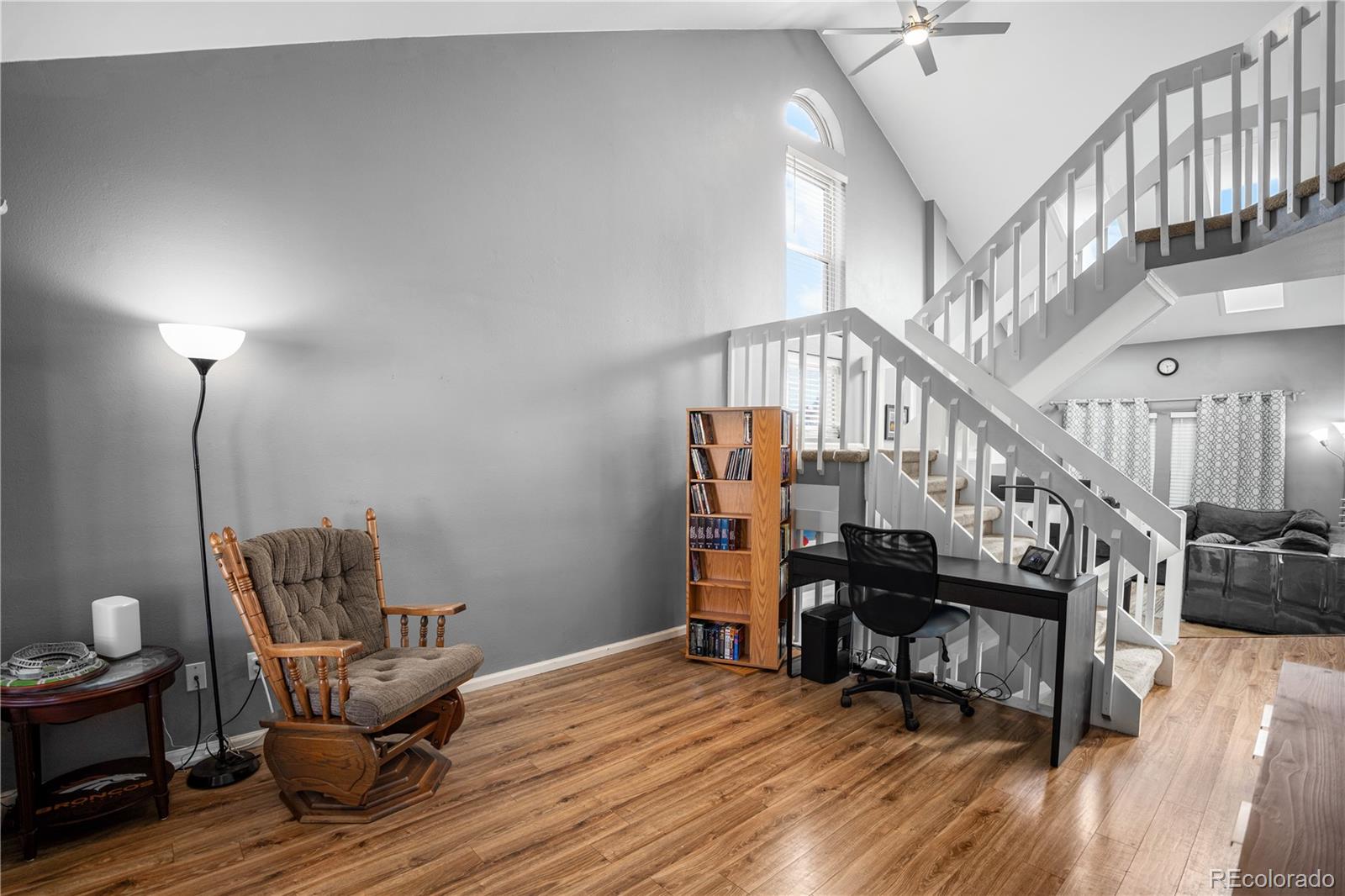 8567 Rabbitbrush Way Parker, CO 80134 - Photo 5 of 46 a room with wooden floor stairs and windows