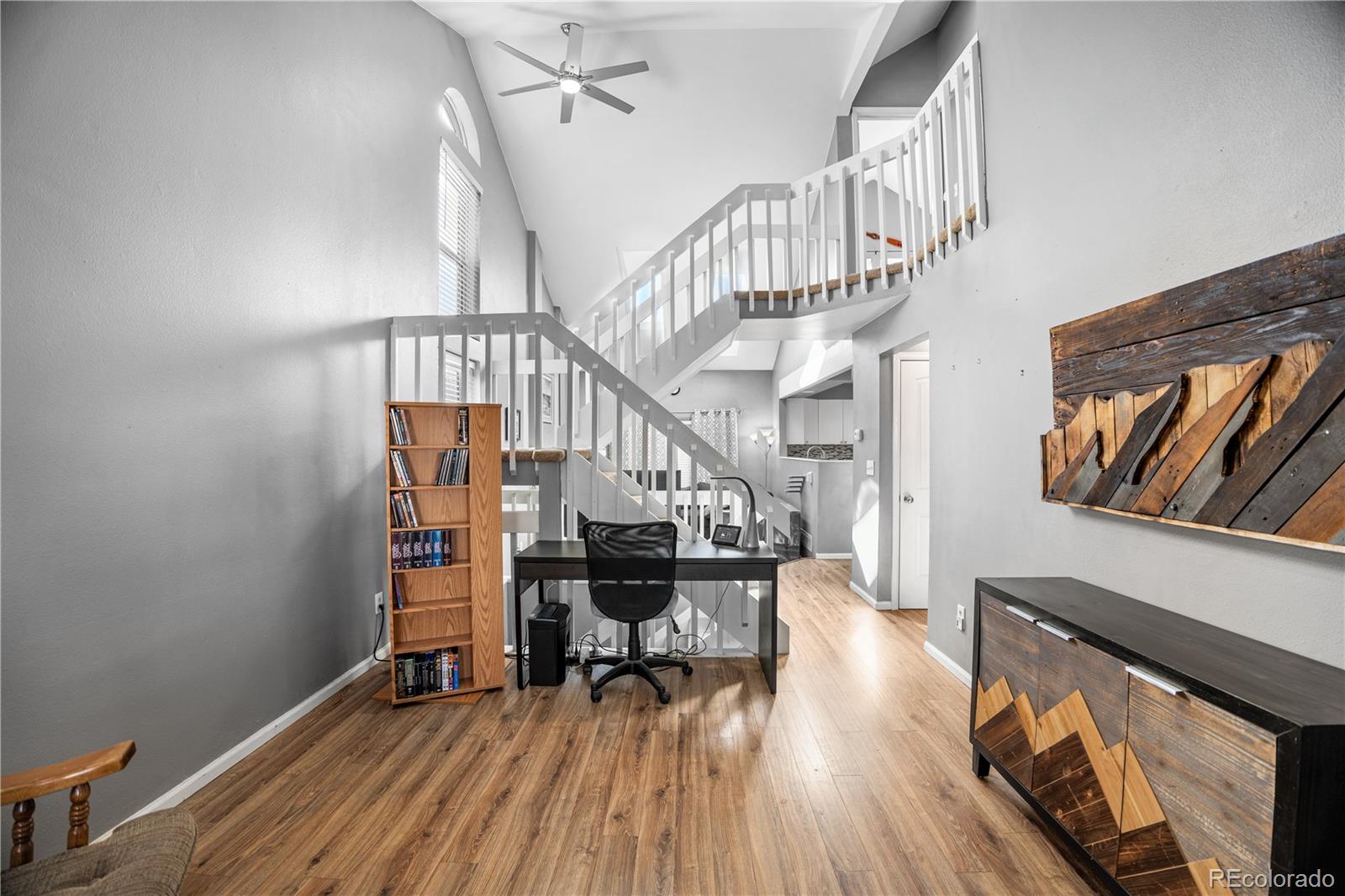 8567 Rabbitbrush Way Parker, CO 80134 - Photo 6 of 46 a view of entryway dining room and hall with wooden floor