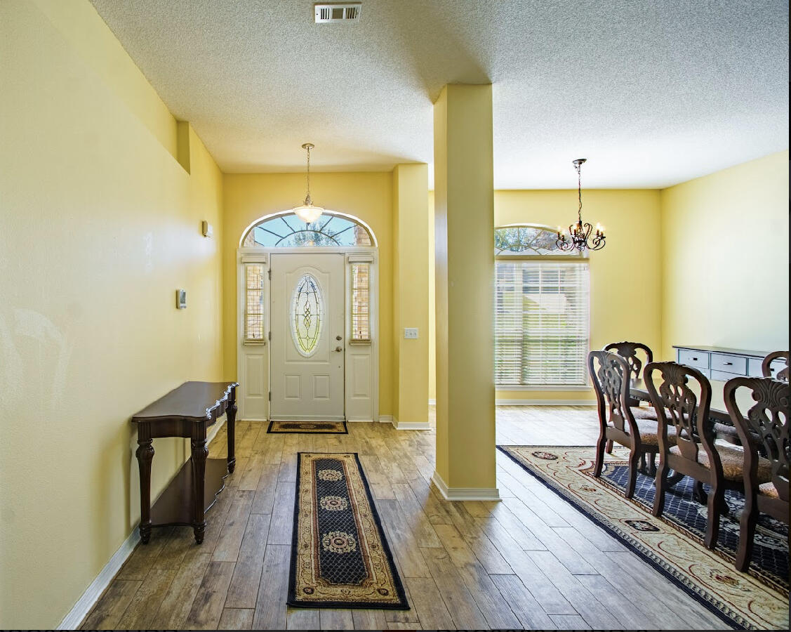232 Raptor Drive Crestview, FL 32536 - Photo 15 of 42 a view of a hallway with wooden floor and furniture