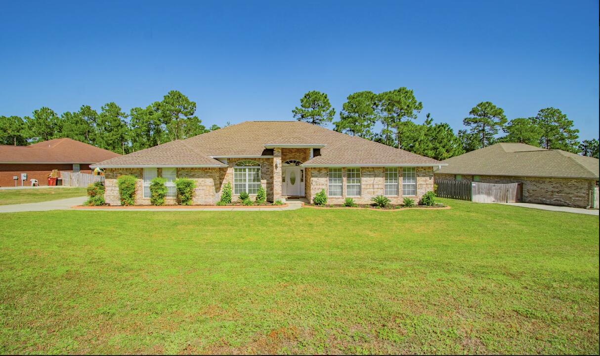 232 Raptor Drive Crestview, FL 32536 - Photo 2 of 42 a front view of a house with garden