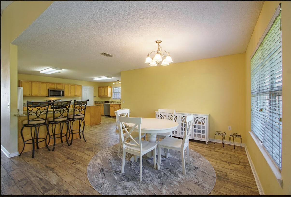 232 Raptor Drive Crestview, FL 32536 - Photo 23 of 42 a view of a dining room with furniture and wooden floor