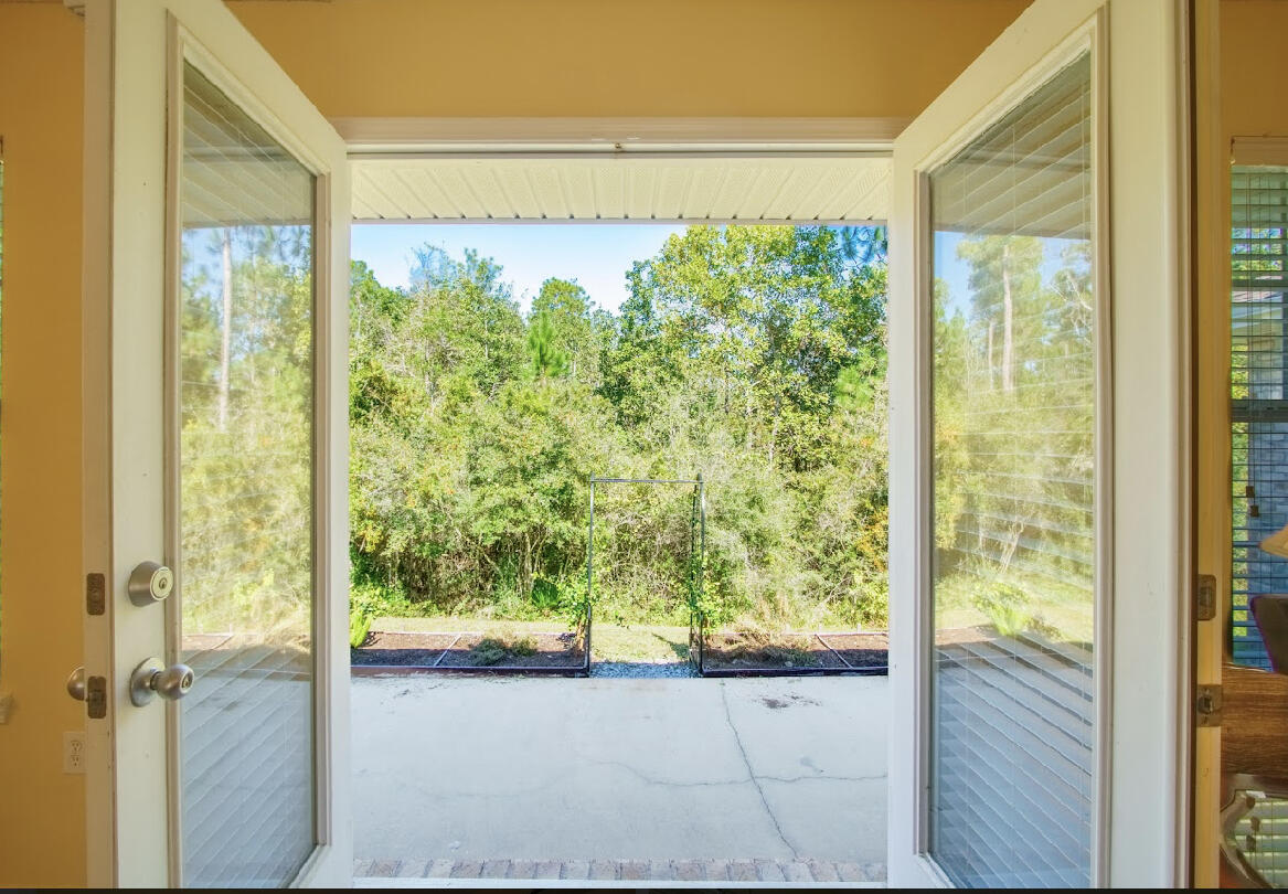 232 Raptor Drive Crestview, FL 32536 - Photo 24 of 42 a view of a porch with a door