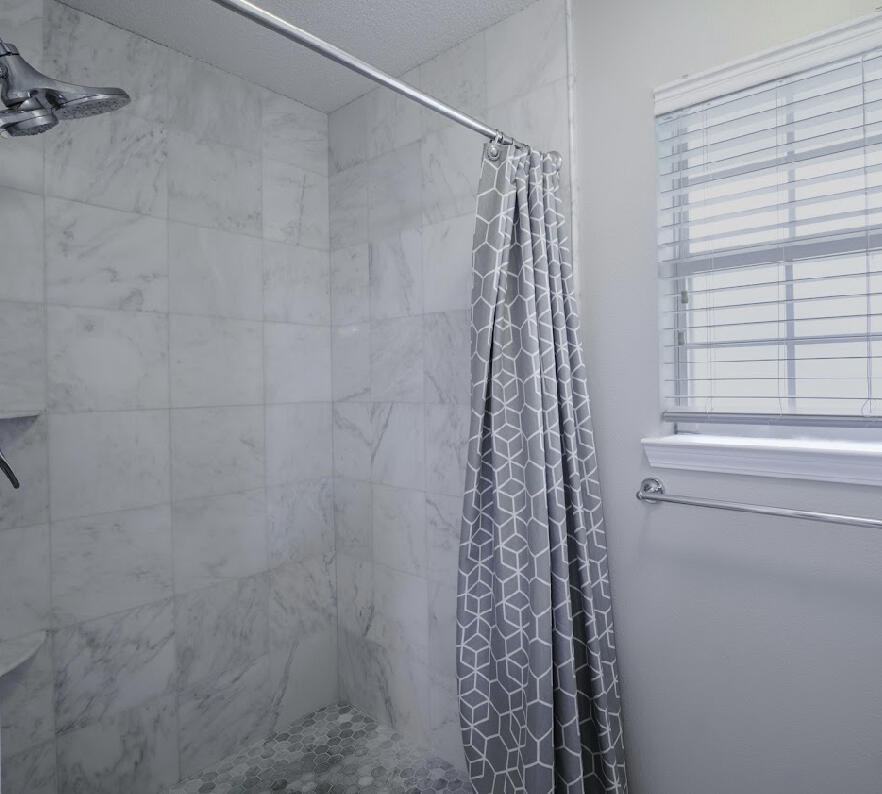 232 Raptor Drive Crestview, FL 32536 - Photo 34 of 42 a bathroom with a shower curtain and window