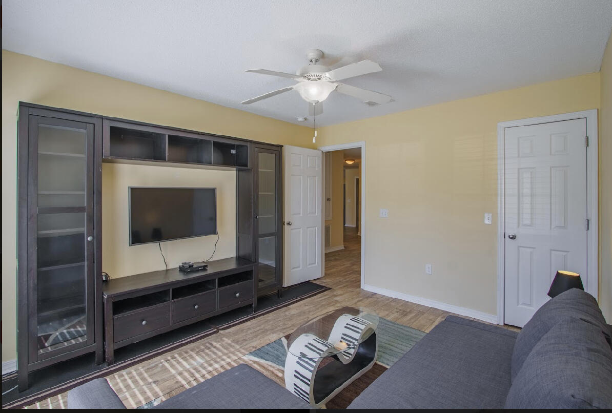 232 Raptor Drive Crestview, FL 32536 - Photo 41 of 42 a living room with furniture and a flat screen tv