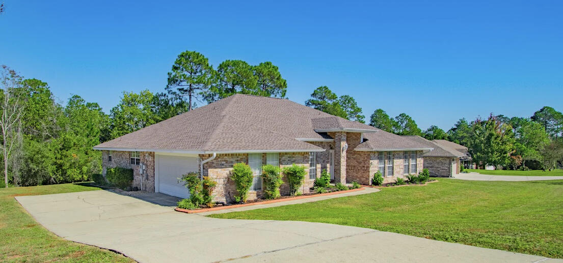 232 Raptor Drive Crestview, FL 32536 - Photo 7 of 42 a front view of a house with a garden