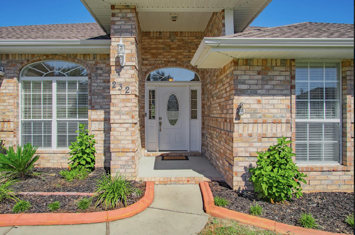 232 Raptor Drive Crestview, FL 32536 - Photo 9 of 42 a front view of a house with garden
