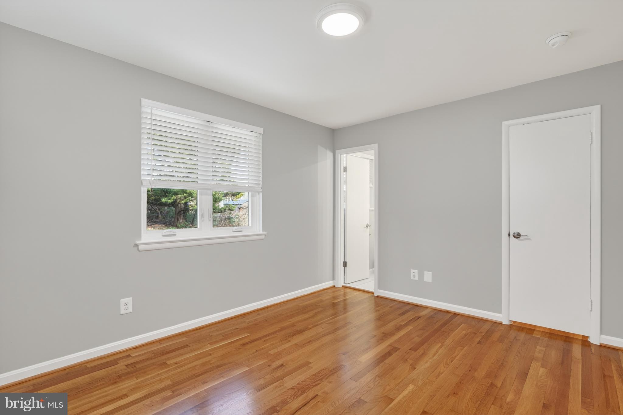 4625 Strathblane Place Alexandria, VA 22304 - Photo 12 of 22 an empty room with wooden floor and windows
