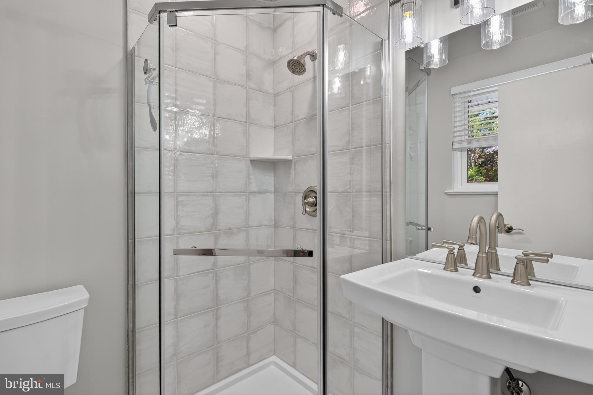 4625 Strathblane Place Alexandria, VA 22304 - Photo 13 of 22 a bathroom with a sink a toilet and shower