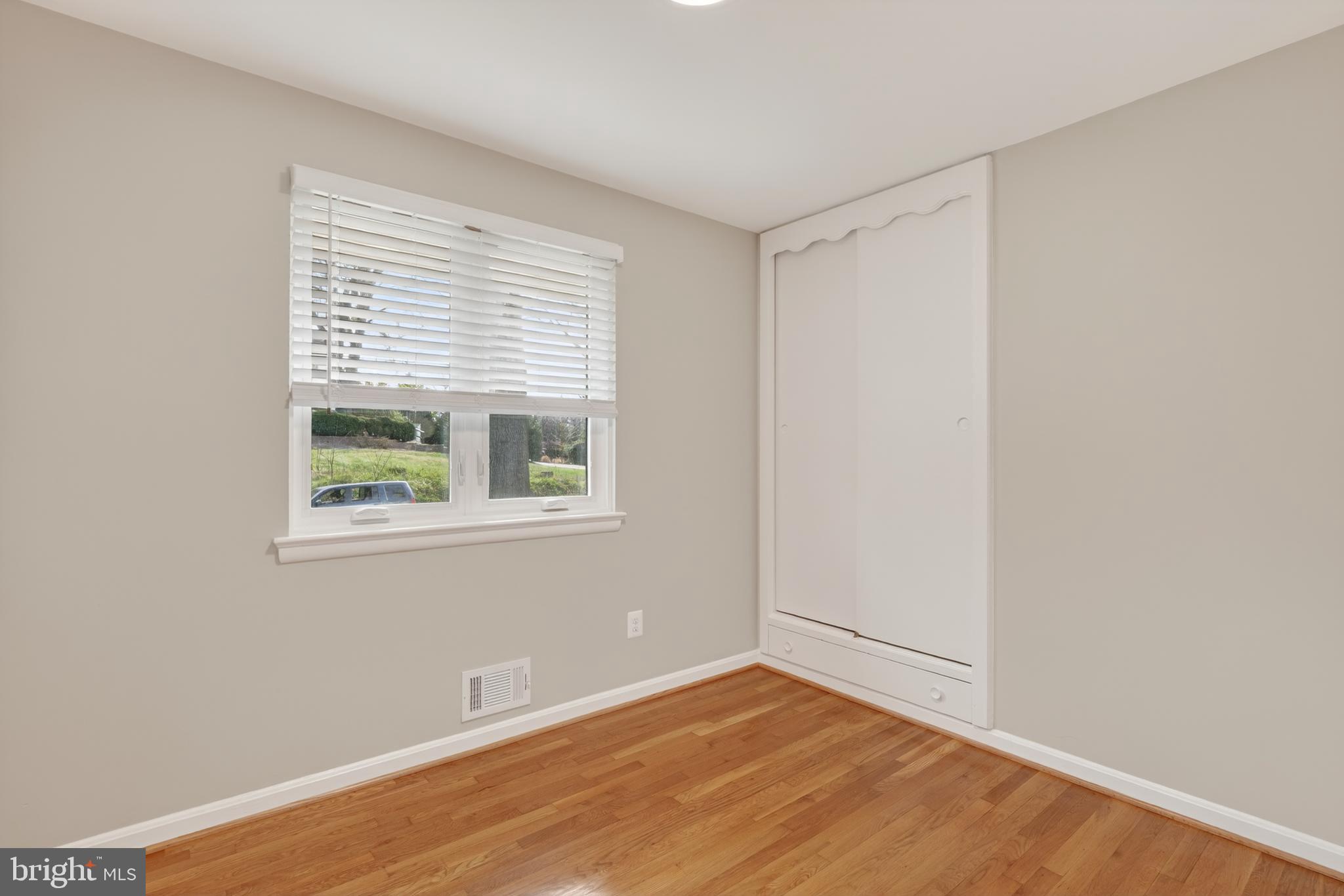 4625 Strathblane Place Alexandria, VA 22304 - Photo 8 of 22 a view of an empty room with wooden floor and a window