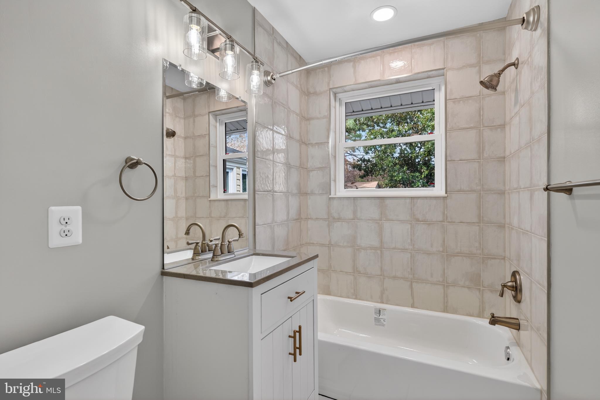 4625 Strathblane Place Alexandria, VA 22304 - Photo 9 of 22 a bathroom with a granite countertop sink a toilet and shower