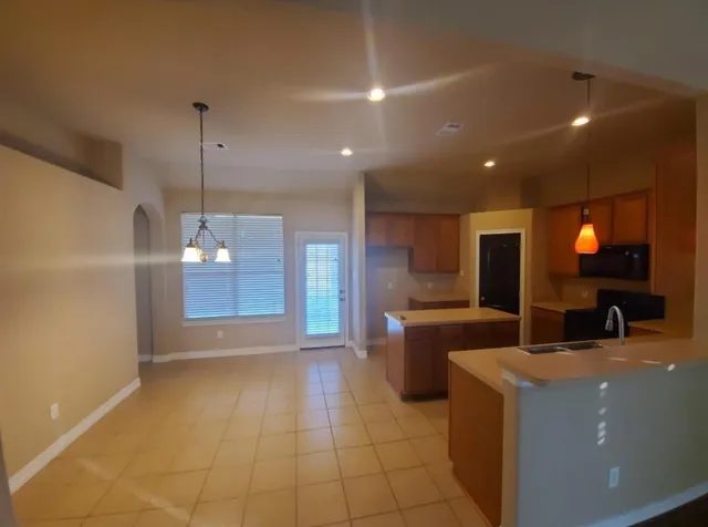 a kitchen with a sink a counter top space and stainless steel appliances