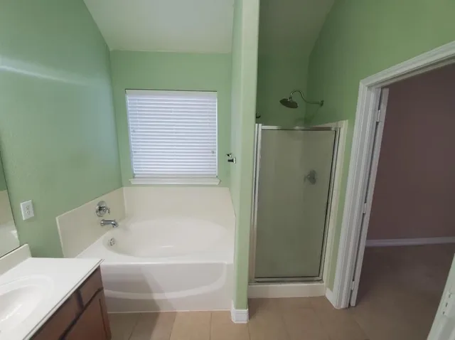 a bathroom with a bathtub and a shower