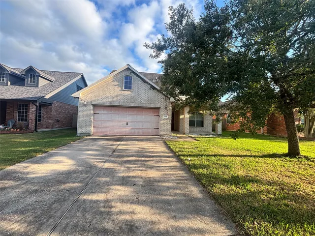 a front view of house with yard and trees