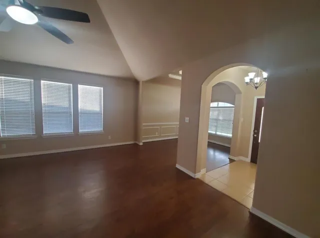 a view of a room with wooden floor and window