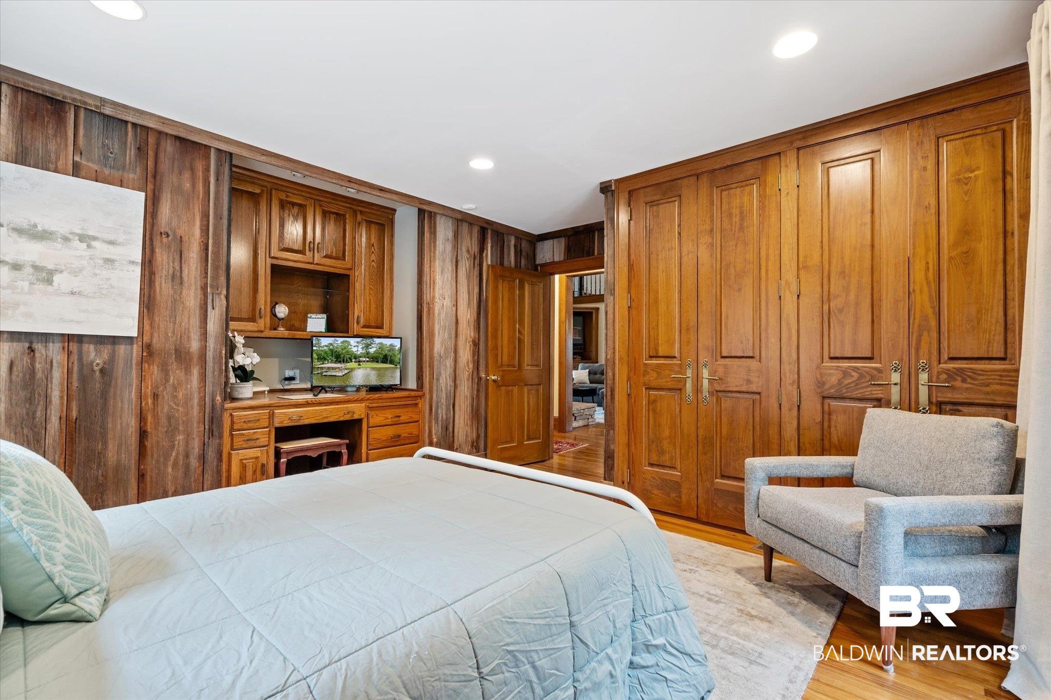2228 Riverside Drive Mobile, AL 36605 - Photo 31 of 51 Bedroom with light wood-type flooring, a closet, wooden walls, and crown molding