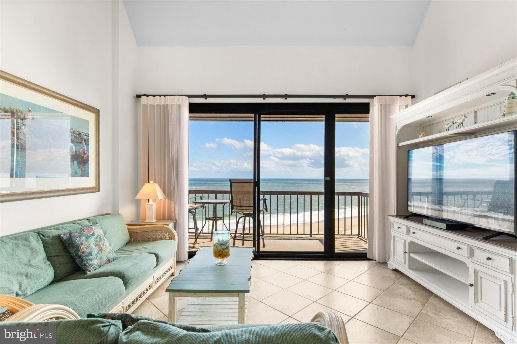 907 Georgetown House, Unit PH07 Bethany Beach, DE 19930 - Photo 2 of 48 a living room with furniture and a flat screen tv