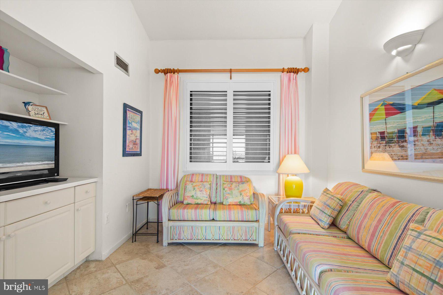 907 Georgetown House, Unit PH07 Bethany Beach, DE 19930 - Photo 30 of 48 a living room with furniture and a flat screen tv