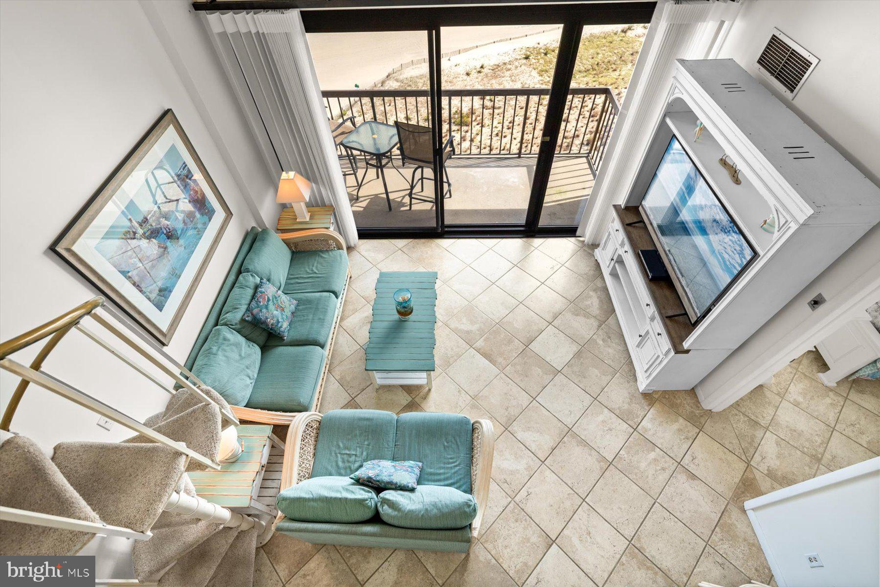 907 Georgetown House, Unit PH07 Bethany Beach, DE 19930 - Photo 33 of 48 a living room with furniture and a floor to ceiling window