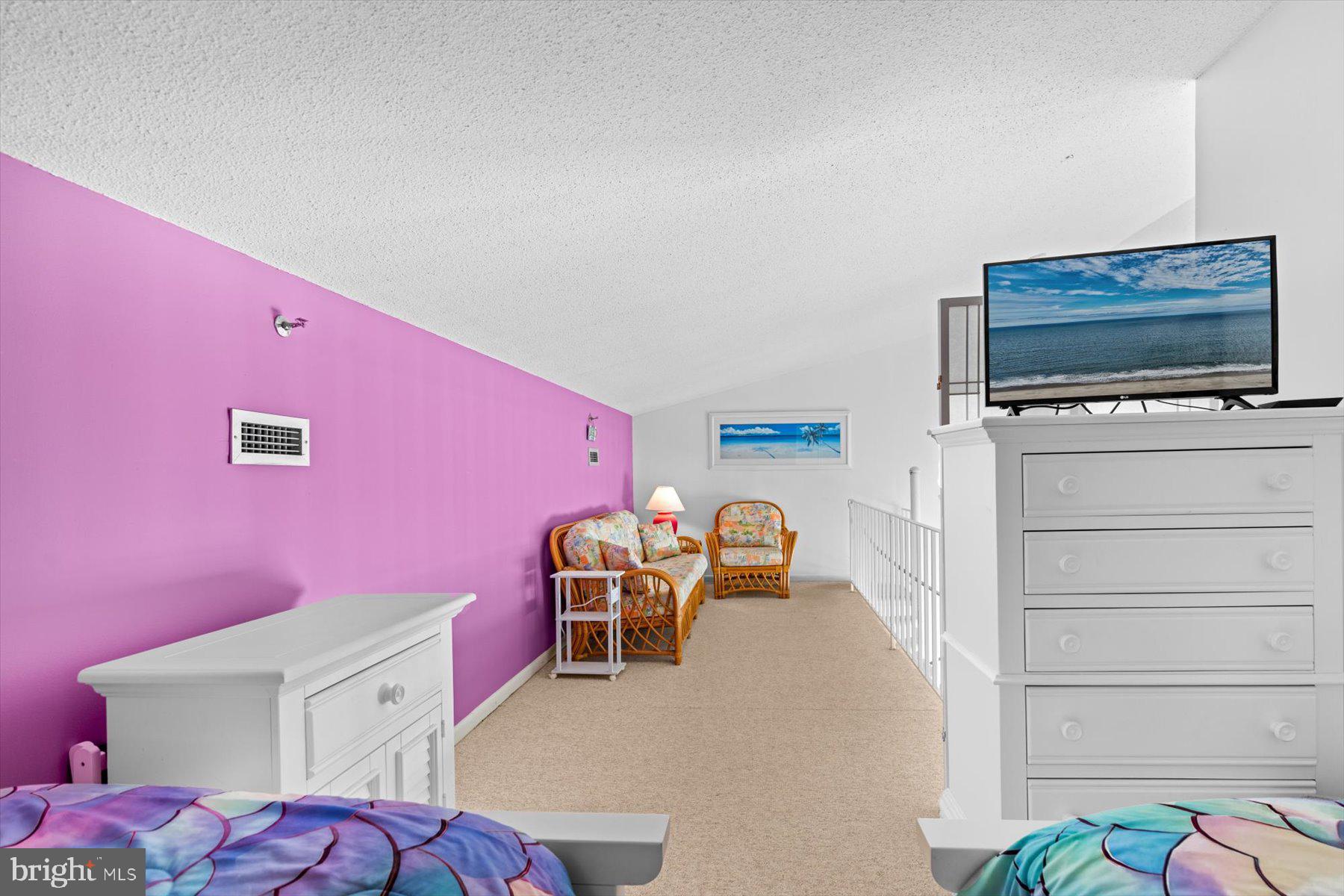 907 Georgetown House, Unit PH07 Bethany Beach, DE 19930 - Photo 36 of 48 a bedroom with furniture and a flat screen tv