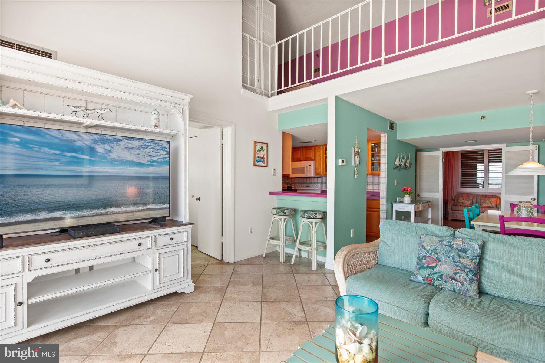 907 Georgetown House, Unit PH07 Bethany Beach, DE 19930 - Photo 7 of 48 a living room with furniture and flat screen tv